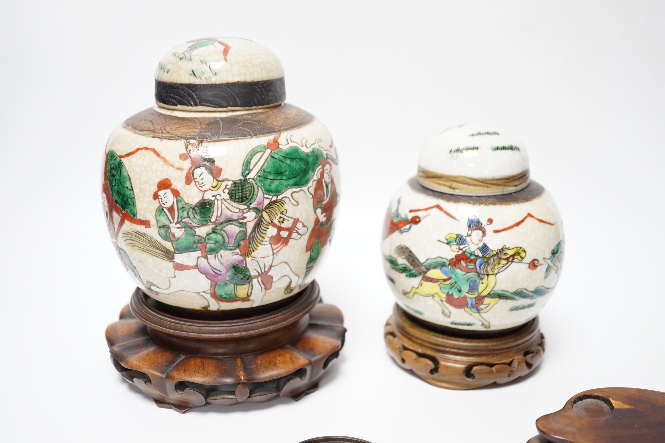 A Chinese famille verte vase, Kangxi period (cut down) and three Chinese polychrome jars with hardwood stands, tallest 19cm